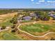 An aerial view shows the clubhouse overlooking the golf course with parking and golf carts nearby at 19504 Lily Pond Ct, Brooksville, FL 34601
