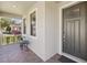 Charming front porch with brick flooring and seating, offering a welcoming entrance to the home at 19504 Lily Pond Ct, Brooksville, FL 34601
