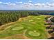 An aerial view of a golf course features golfers enjoying a game on the greens at 19504 Lily Pond Ct, Brooksville, FL 34601