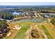Scenic aerial view of golf course with lush greens, sand bunkers, and serene water hazards at 19504 Lily Pond Ct, Brooksville, FL 34601