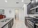 Modern kitchen featuring granite countertops, stainless steel appliances, and dark cabinets at 19504 Lily Pond Ct, Brooksville, FL 34601