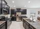 Well-equipped kitchen with stainless steel appliances, granite countertops, and dark wood cabinetry at 19504 Lily Pond Ct, Brooksville, FL 34601