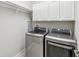 Laundry room featuring a modern LG washer and dryer set, with white cabinets for storage at 19504 Lily Pond Ct, Brooksville, FL 34601