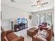 Comfortable living room features a ceiling fan and sliding glass doors to outdoor patio at 19504 Lily Pond Ct, Brooksville, FL 34601
