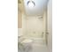 Bathroom showing white toilet and tub with tiled walls and updated fixtures at 2101 Sunset Point Rd # 2706, Clearwater, FL 33765