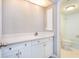 Bathroom with white cabinetry, a solid surface countertop and a view into the bath and toilet area at 2101 Sunset Point Rd # 2706, Clearwater, FL 33765