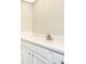 Bathroom vanity with white cabinets, chrome hardware, and a white countertop with integrated sink at 2101 Sunset Point Rd # 2706, Clearwater, FL 33765