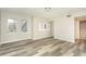 Well-lit bedroom features wood-look floors, neutral paint, and ample windows for natural light and ventilation at 2101 Sunset Point Rd # 2706, Clearwater, FL 33765