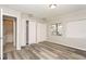 Cozy bedroom with vinyl wood flooring, natural light, and closet and ensuite bathroom access at 2101 Sunset Point Rd # 2706, Clearwater, FL 33765