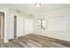 Bright bedroom featuring modern flooring, two windows, and ample closet space at 2101 Sunset Point Rd # 2706, Clearwater, FL 33765