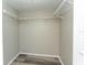 Walk-in closet with durable vinyl flooring and wire rack shelving for efficient storage at 2101 Sunset Point Rd # 2706, Clearwater, FL 33765