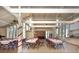 Community clubhouse with a kitchen, tables, chairs, and stone fireplace at 2101 Sunset Point Rd # 2706, Clearwater, FL 33765