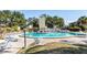 Outdoor pool with lounge chairs and tables for community residents to enjoy on a sunny day at 2101 Sunset Point Rd # 2706, Clearwater, FL 33765