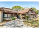 Charming single-story home with brown siding, a concrete driveway, and a well-manicured front yard at 2101 Sunset Point Rd # 2706, Clearwater, FL 33765