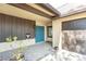 Inviting front porch area with a double blue front door, brick accent and attached garage at 2101 Sunset Point Rd # 2706, Clearwater, FL 33765