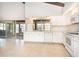 Well-lit kitchen area offering ample counter space, white cabinetry, and a window overlooking the backyard at 2101 Sunset Point Rd # 2706, Clearwater, FL 33765