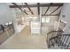 Open-concept kitchen boasts white cabinets, stainless appliances, and ceiling beams, providing a warm and inviting space at 2101 Sunset Point Rd # 2706, Clearwater, FL 33765