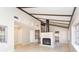 Spacious living room features a brick fireplace, vaulted ceilings, and tile floors at 2101 Sunset Point Rd # 2706, Clearwater, FL 33765