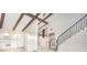 Bright living room featuring vaulted ceilings, exposed beams, and an open floor plan perfect for entertaining at 2101 Sunset Point Rd # 2706, Clearwater, FL 33765