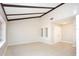 Bright living room with vaulted ceiling, neutral walls and floor, and accent beams at 2101 Sunset Point Rd # 2706, Clearwater, FL 33765