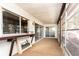 Covered outdoor patio with brown carpeting and sliding glass doors leads to the interior at 2101 Sunset Point Rd # 2706, Clearwater, FL 33765