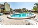 Community pool surrounded by lounge chairs and clear blue water at 2101 Sunset Point Rd # 2706, Clearwater, FL 33765