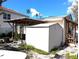 Exterior side view of the home featuring a covered patio area and white storage shed at 222 84Th N Ave, St Petersburg, FL 33702