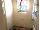 Damaged bathroom with missing drywall, visible mold, and outdated fixtures, needing renovations at 222 84Th N Ave, St Petersburg, FL 33702