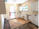 Kitchen area that has been cleared with the cabinets partially removed and subflooring visible at 222 84Th N Ave, St Petersburg, FL 33702