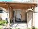 Covered patio area with a white storage shed and sliding glass door access to the home at 222 84Th N Ave, St Petersburg, FL 33702