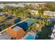 Community aerial view showing the tennis court, parking, and landscaping at 2440 Winding Creek Blvd # 305, Clearwater, FL 33761