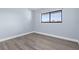 Light and airy bedroom with a large window and attractive gray flooring at 2440 Winding Creek Blvd # 305, Clearwater, FL 33761