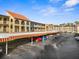 Condominium building featuring multiple balconies and covered parking at 2440 Winding Creek Blvd # 305, Clearwater, FL 33761