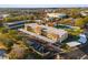 Aerial view of the condos with covered parking, a tennis court and beautifully landscaped grounds at 2440 Winding Creek Blvd # 305, Clearwater, FL 33761