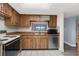 Kitchen with wood cabinets, stainless steel appliances, and tile flooring at 2440 Winding Creek Blvd # 305, Clearwater, FL 33761