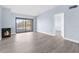 Bright living area featuring a fireplace and access to outdoor views through a sliding door at 2440 Winding Creek Blvd # 305, Clearwater, FL 33761