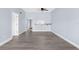 An expansive living room shows modern flooring, a breakfast bar, and open access to the hallway at 2440 Winding Creek Blvd # 305, Clearwater, FL 33761