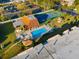 Aerial view of the community pool, spa, tennis court, and outdoor seating areas at 2440 Winding Creek Blvd # 305, Clearwater, FL 33761