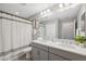 Bright bathroom featuring a large mirror, double vanity with quartz countertop and tiled floors at 29917 Southwell Ln, Wesley Chapel, FL 33543