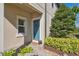 Attractive entryway features a blue front door, manicured landscaping, and stone pathway at 29917 Southwell Ln, Wesley Chapel, FL 33543