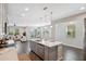 Spacious kitchen with island sink overlooks the dining area and sun-filled living room at 29917 Southwell Ln, Wesley Chapel, FL 33543