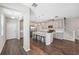 Modern kitchen featuring stainless appliances, center island with bar seating, and wood flooring at 29917 Southwell Ln, Wesley Chapel, FL 33543
