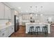 Stylish kitchen features stainless appliances, light countertops, and island with seating at 29917 Southwell Ln, Wesley Chapel, FL 33543