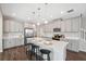 Bright kitchen with stainless steel appliances, granite countertops, and center island with barstools at 29917 Southwell Ln, Wesley Chapel, FL 33543