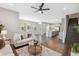 Spacious living room featuring hardwood floors, neutral colors, and an open layout connecting to the kitchen area at 29917 Southwell Ln, Wesley Chapel, FL 33543