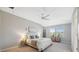 Bright main bedroom featuring a ceiling fan and a large window with natural light at 29917 Southwell Ln, Wesley Chapel, FL 33543