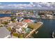 Stunning aerial view of waterfront homes with docks, boats, and a community swimming pool at 3073 Gulf Winds Cir, Hernando Beach, FL 34607