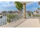 Balcony overlooking water features white railings and architectural columns at 3073 Gulf Winds Cir, Hernando Beach, FL 34607