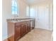 Wet bar with dark wood cabinets, stone countertops, wine fridge, and arched windows at 3073 Gulf Winds Cir, Hernando Beach, FL 34607