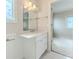 Bathroom features a white vanity with marble countertop and a large mirror at 3073 Gulf Winds Cir, Hernando Beach, FL 34607